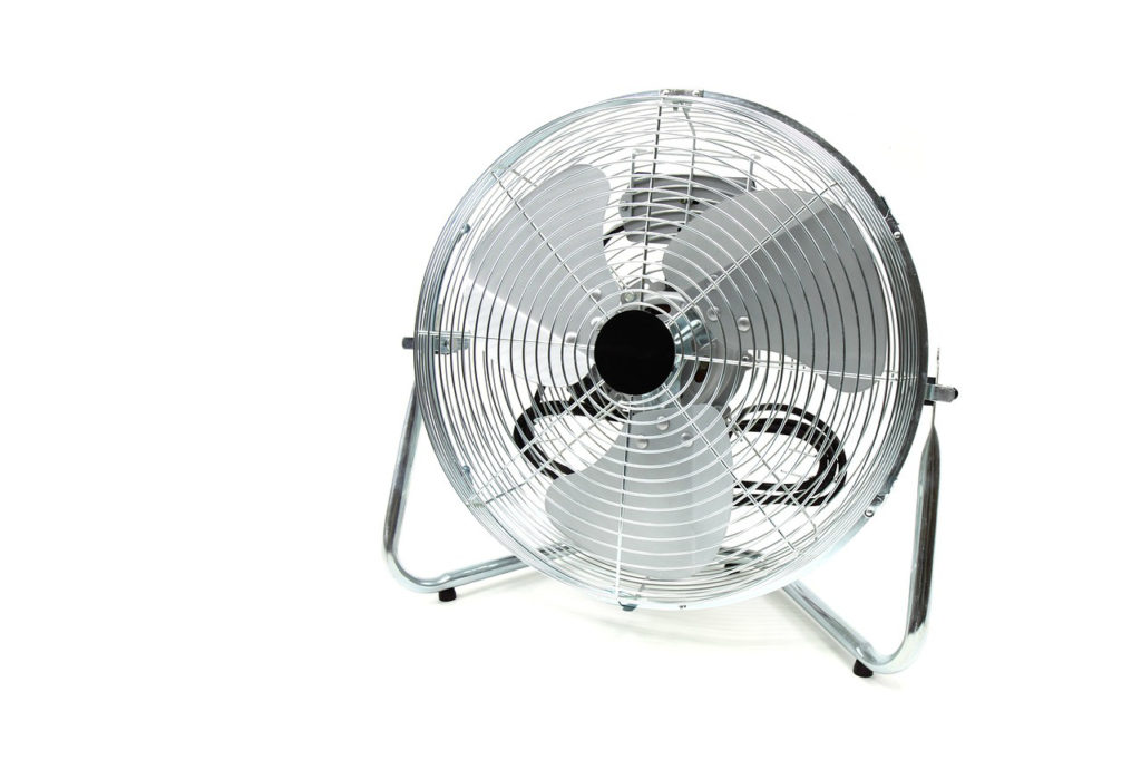 Rotor eines Standventilators hinter dem Schutzgitter